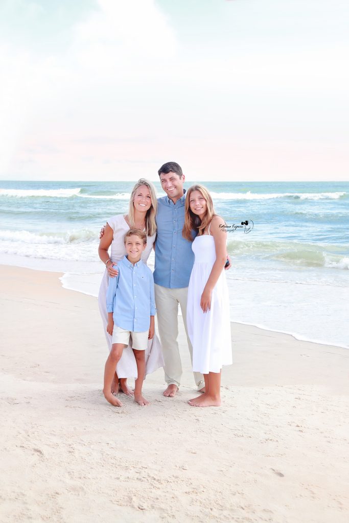 Joyful family playing by the ocean, captured in a scenic beach photography session.