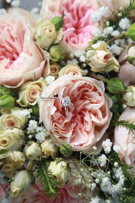 Close-up of an elegant bridal bouquet with soft roses and eucalyptus, photographed among the formal gardens at Washington Oaks Gardens State Park.