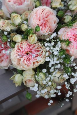 Close-up of an elegant bridal bouquet with soft roses and eucalyptus, photographed among the formal gardens at Washington Oaks Gardens State Park.