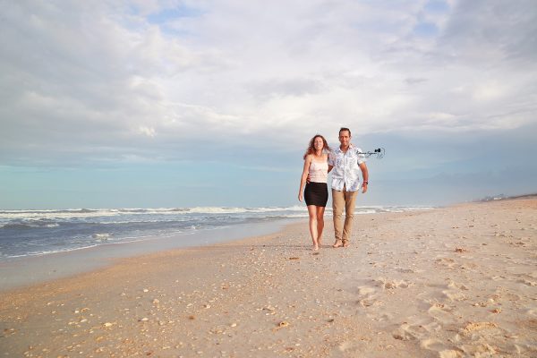 Engaged couple on the beach at Washington Oaks Gardens.