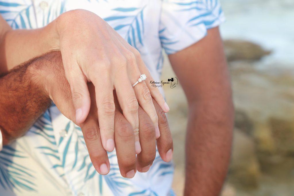 Engaged couple on the beach at Washington Oaks Gardens.